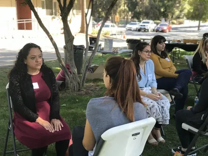 Melina Sardar leading an outdoor group conversation
