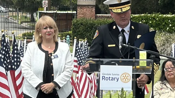 Melina Sardar speaking alongside a fire chief