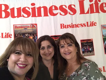 Melina Sardar with colleagues at a business community event